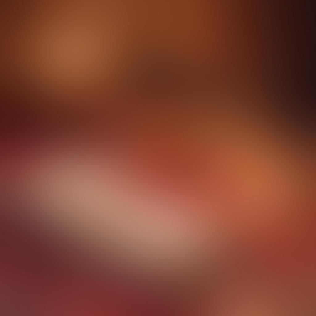 A romantic scene depicting a couple intertwined among softly lit candles and rose petals, surrounded by erotic literature books scattered around them. The ambiance radiates warmth and intimacy, with a hint of mystery and allure in their expressions. The background should be dimly lit, enhancing the focus on their passionate connection. The overall color palette should feature deep reds and golds to evoke a sense of seduction. super-realistic. warm glow. intimate atmosphere.